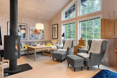 a living room with chairs and a fireplace at Fagerasen 303 by Vacation Trysil in Trysil