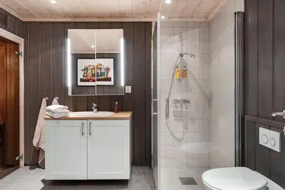 a bathroom with a toilet and a sink and a shower at Fagerasen 303 by Vacation Trysil in Trysil