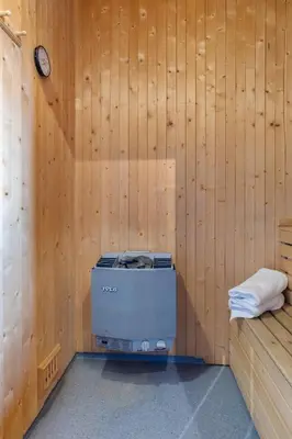 a room with a stove in a wooden wall at Trysilfjell 615 by Vacation Trysil in Trysil