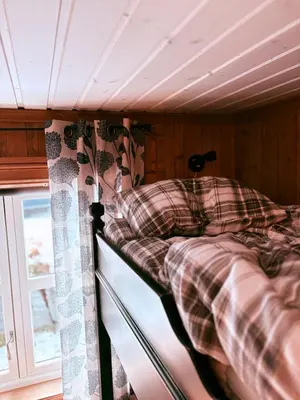 a bunk bed in a room with a window at Nikolaisens Nordic Panorama hideaway in Stranda