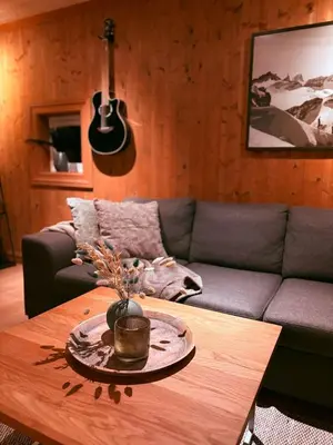 a living room with a couch and a table at Nikolaisens Nordic Panorama hideaway in Stranda