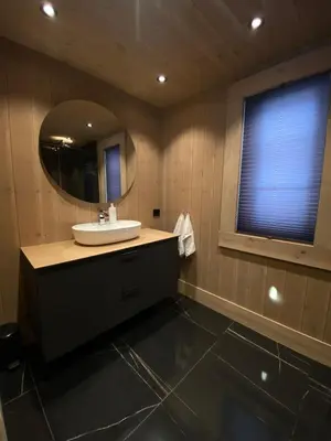 a bathroom with a sink and a mirror at Exclusive cottage on Geilo in Hol