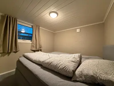a small bedroom with a bed and a window at Ny leilighet i Stjørdal in Stjoerdal