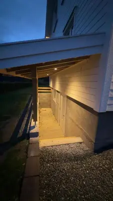 a porch of a house with the lights on at Ny leilighet i Stjørdal in Stjoerdal