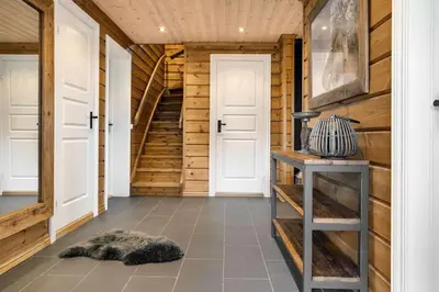 a hallway with wooden walls and a staircase in a house at Trysilfjell hytteområde 922 by Vacation Trysil in Trysil