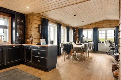 a kitchen and dining room with a table and chairs at Trysilfjell hytteområde 922 by Vacation Trysil in Trysil