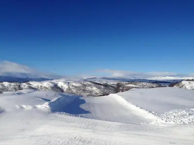 a snow covered mountain with a trail in the snow at Skarslia Apartment in Skarsgård