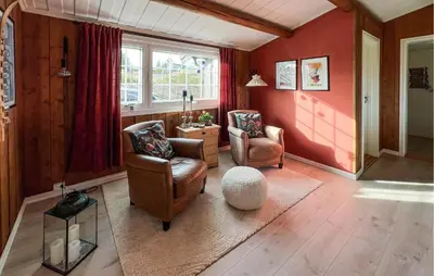 a living room with two chairs and a window at Amazing Home In Sjusjøen With Sauna in Sjusjøen