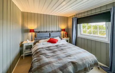 a bedroom with a large bed with a window at Amazing Home In Sjusjøen With Sauna in Sjusjøen