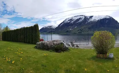 a view of a lake with a snow covered mountain at JOlster apartaments - lake view in Årdal
