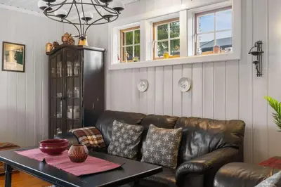 a living room with a leather couch and a table at Fageråsen 209 by Vacation Trysil in Trysil