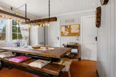 a dining room with a table and a bench at Fageråsen 209 by Vacation Trysil in Trysil