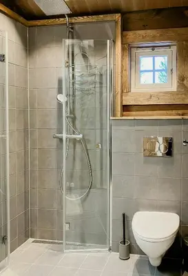 a bathroom with a shower and a toilet at Newly Built Log Cabin Near Hardangervidda in Geilo