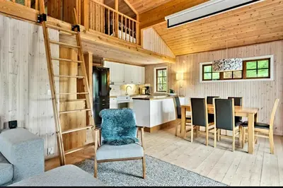 a kitchen and dining room with a ladder in a house at Filefjellhytta ved Tyin og Jotunheimen Ski in og ski out til alpinanlegg og skiløyper in Tyinkrysset