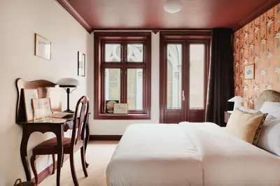 a bedroom with a bed and a desk and a window at Bryggen Boutique l Stay Uniquely l 2 min to Floyen in Bergen