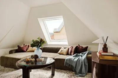 a living room with a couch and a window at Bryggen Boutique l Stay Uniquely l 2 min to Floyen in Bergen
