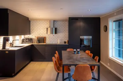 a kitchen with a table and chairs in a kitchen at Trysilfjellet Nord 985A in Trysil