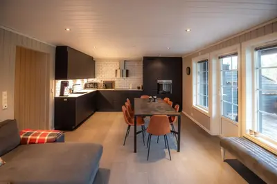 a kitchen and dining room with a table and chairs at Trysilfjellet Nord 985A in Trysil