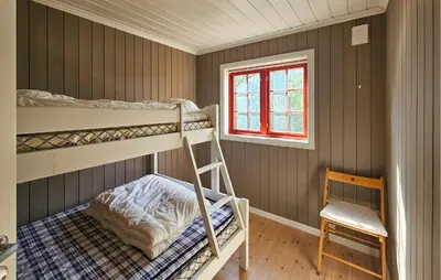 a bedroom with two bunk beds and a chair at Gorgeous Home In Eggedal With Sauna in Eggedal