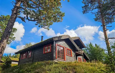 a small house with red windows on a hill at Gorgeous Home In Eggedal With Sauna in Eggedal