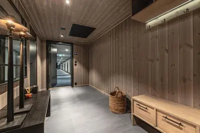 a hallway with wood paneled walls and a hallway with a basket at Brand new luxury apartment by the slopes, Hemsedal in Hemsedal