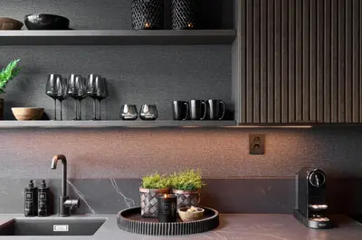a kitchen with a sink and a counter with plants at Hideaway Herdla luxurious cabins 15 m above the sea in Herlø