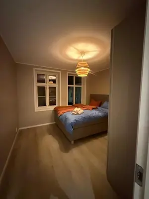 a bedroom with a bed and a window at Beautiful 3 room apartment centrally located in Sandviken in Bergen