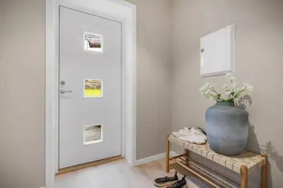 a vase sitting on a table next to a door at Beautiful 3 room apartment centrally located in Sandviken in Bergen
