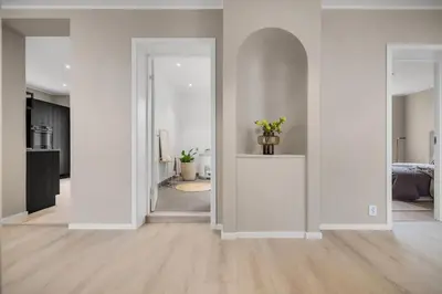 an empty living room with white walls and wood floors at Beautiful 3 room apartment centrally located in Sandviken in Bergen