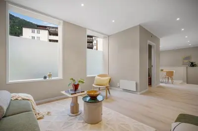 a living room with a couch and a large window at Beautiful 3 room apartment centrally located in Sandviken in Bergen