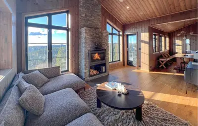 a living room with a couch and a fireplace at Stunning Home In Noresund With Sauna in Noresund