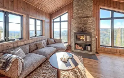 a living room with a couch and a fireplace at Stunning Home In Noresund With Sauna in Noresund