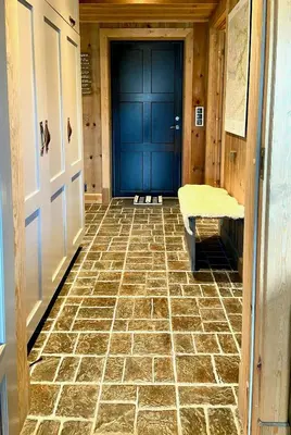 a hallway with a blue door and a tiled floor at Flat With Panoramic Views Of Hallingskarvet in Geilo