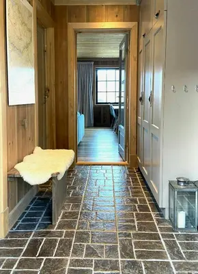 a room with a hallway with a stone floor at Flat With Panoramic Views Of Hallingskarvet in Geilo