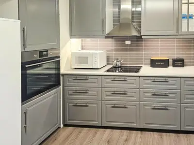 a kitchen with stainless steel cabinets and a microwave at Charming Farm Stay On Averøy Island in Averoy