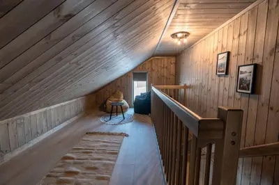 a wooden hallway with a staircase in a house at Cozy Family Cabin Ski centre, shuttle bus in Noresund