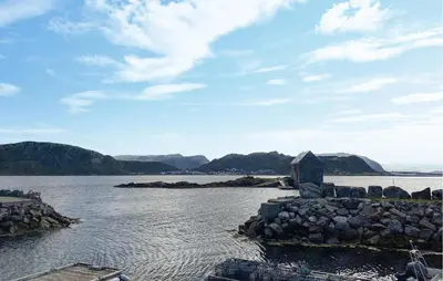 a view of a body of water with a building at 4 Bedroom Lovely Home In Leinøya in Fosnavåg