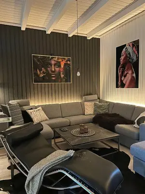 a living room with a couch and a table at Modern and spacious home in Trondheim
