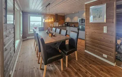 a dining room with a wooden table and chairs at Cozy Home In Ulnes With Sauna in Ulnes