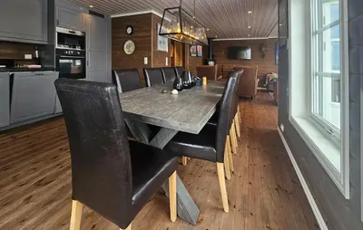 a dining room with a wooden table and black chairs at Cozy Home In Ulnes With Sauna in Ulnes