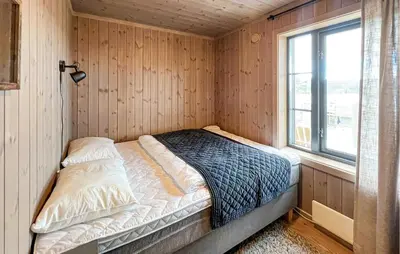 a bed in a corner of a room with a window at Amazing Home In Gålå With Sauna in Gålå
