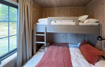 a bedroom with two bunk beds and a window at Amazing Home In Gålå With Sauna in Gålå
