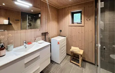 a bathroom with a white sink and a shower at Amazing Home In Gålå With Sauna in Gålå
