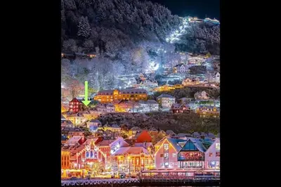 a view of a town at night with lights at 2-roms leilighet med spektakulær utsikt og privat hage in Bergen