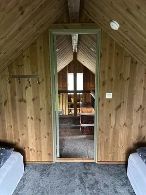 a room with wooden walls and a door in a room at Architectural gem with fjord view in Holmedal