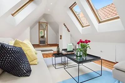 a living room with a white couch and a table at Historic Apartment in the Heart of Bergen in Bergen