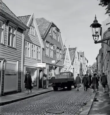 a black and white photo of a street with a truck at Historic Apartment in the Heart of Bergen in Bergen