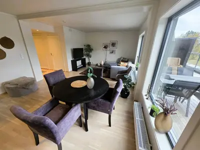 a living room with a table and chairs and a couch at Nice apartment in the center of Trysil 403 in Trysil
