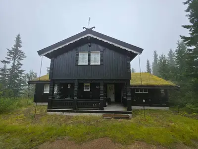 a large black house with a grass roof at Cozy Cabin Retreat in Trysil, Norway for Families in Trysil