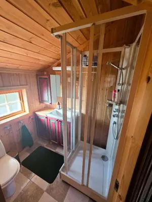 a small bathroom with a shower and a toilet at Cozy Cabin Retreat in Trysil, Norway for Families in Trysil